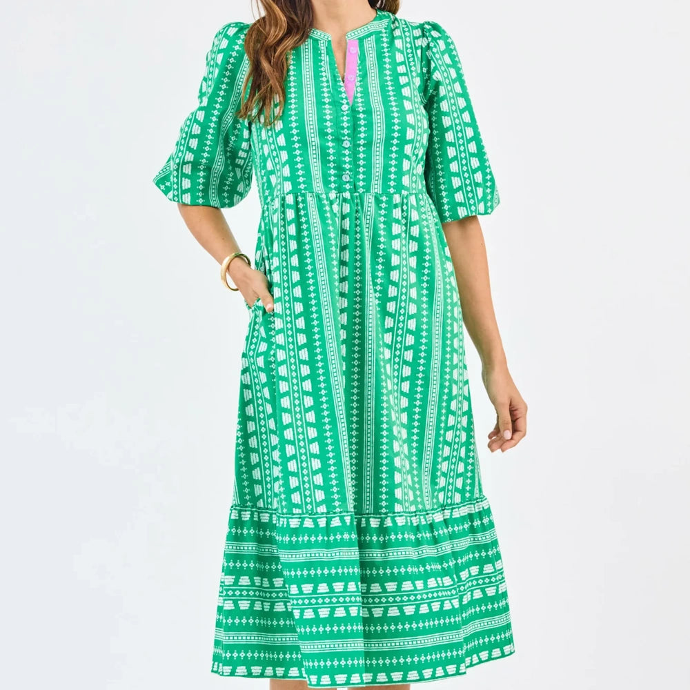 Green Riley midi dress with white heritage stitch pattern, puff sleeves, tiered skirt, and pink button placket.