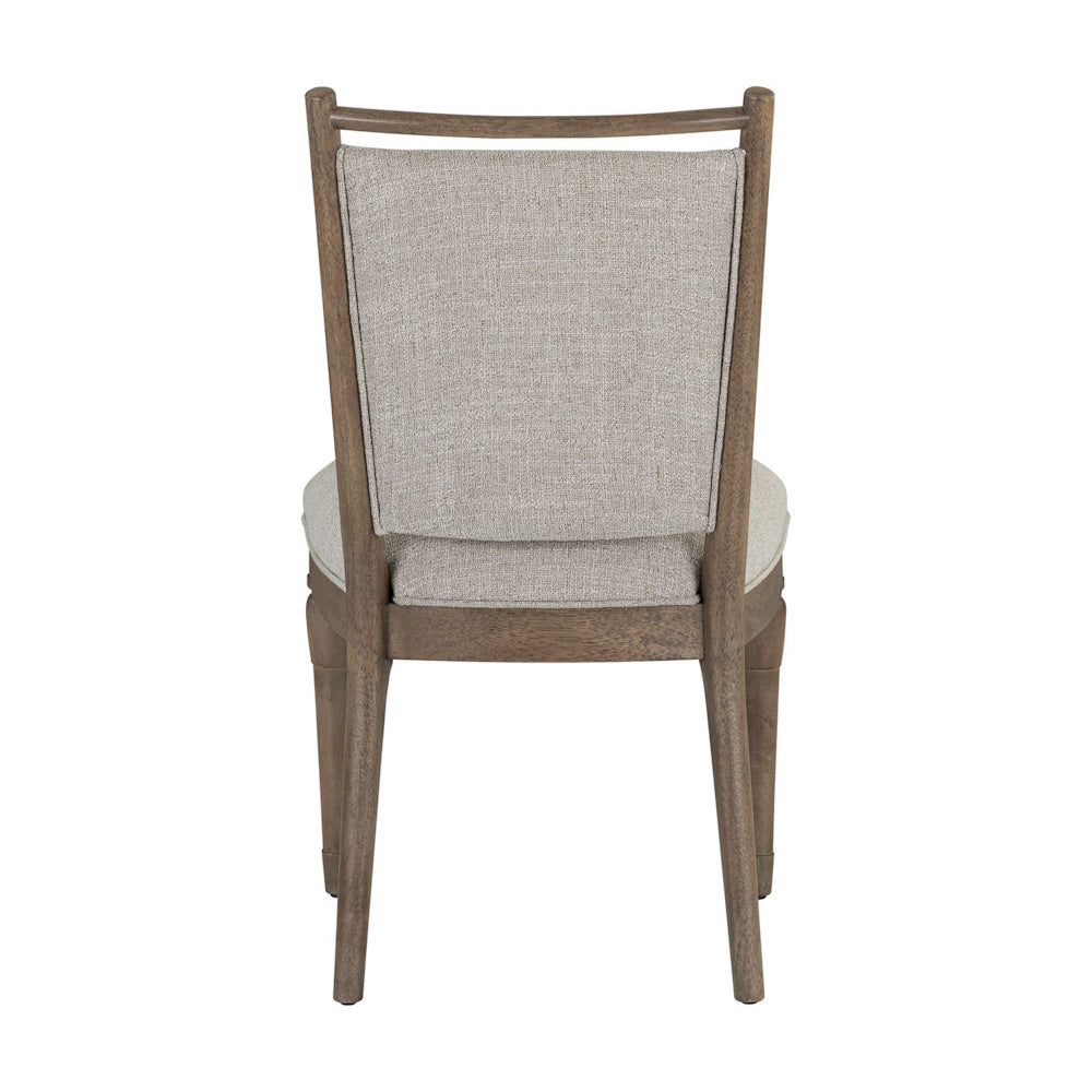 Back view of a Hickory Grove dining chair featuring a light gray upholstered backrest and a brown wooden frame.