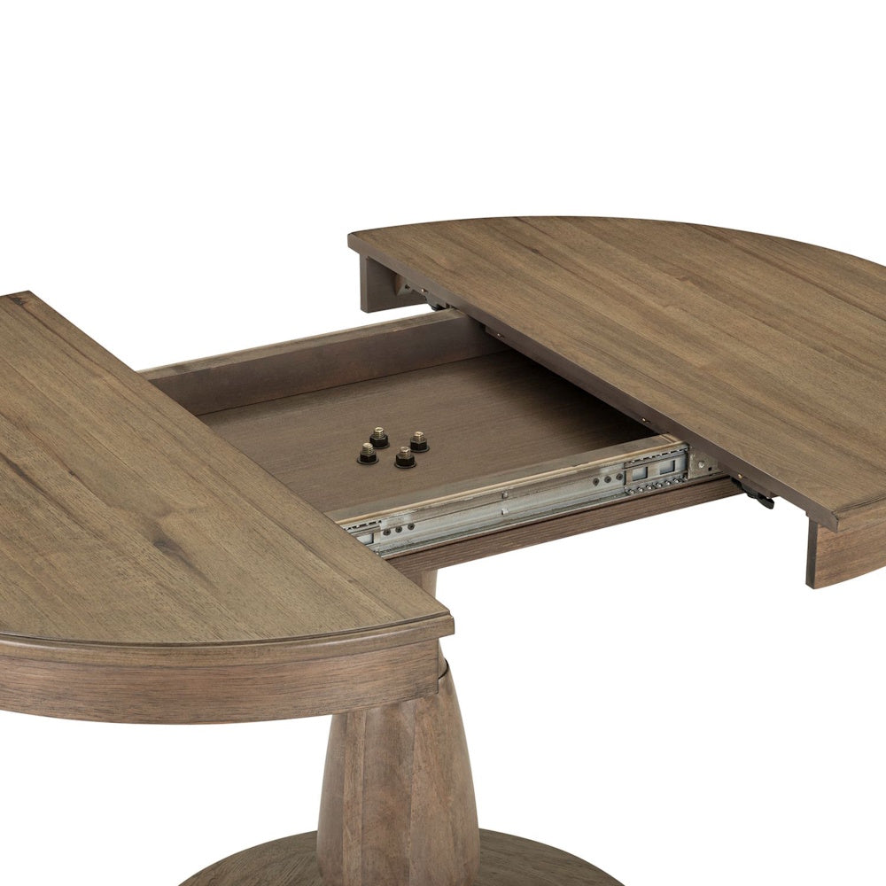 An extendable wooden pedestal dining table pulled apart to show the metal gear slides and extension mechanism.