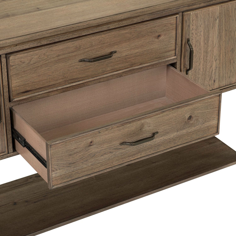 Close-up of an open wooden drawer on a rustic sideboard buffet with metal handles and metal glides.