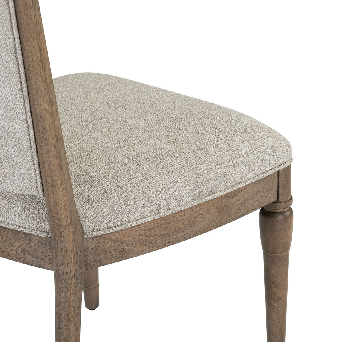 Close up of textured beige fabric seat cushion on a Hickory Grove upholstered wooden dining chair.