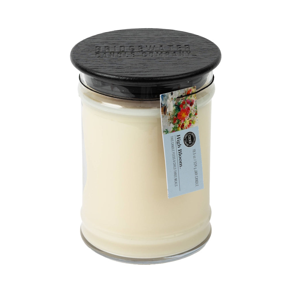 Bridgewater High Bloom 18.5 oz Jar Candle with black wood lid and Light a Candle Feed a Child tag.