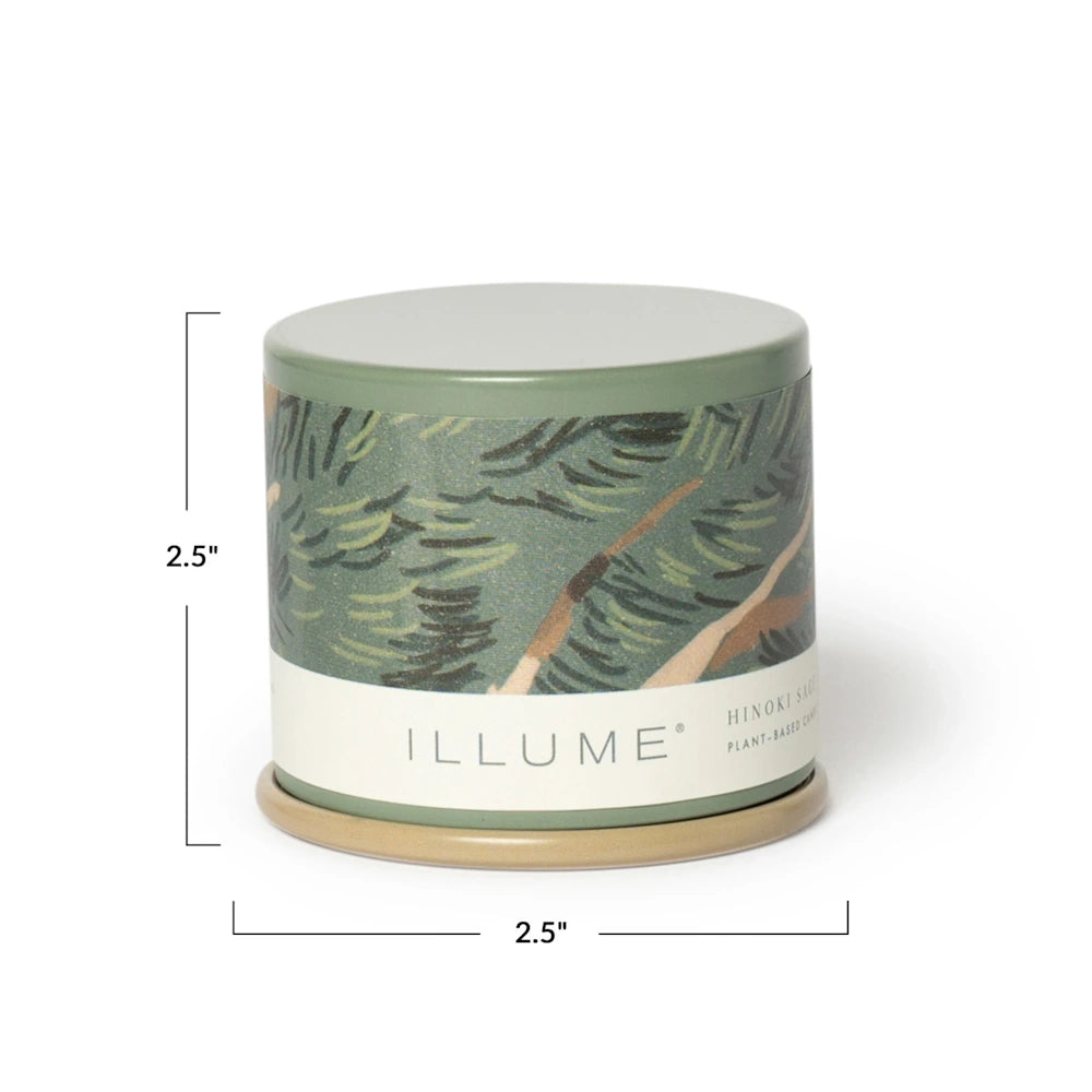 Green Illume candle tin with pine tree pattern, showing dimensions of 2.5 inches high by 2.5 inches wide.