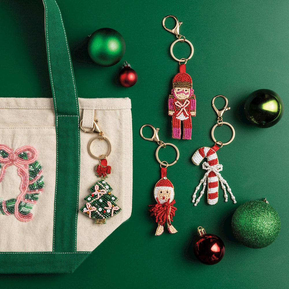 Beaded holiday bag charms featuring a Christmas tree, nutcracker, Santa, and candy cane.