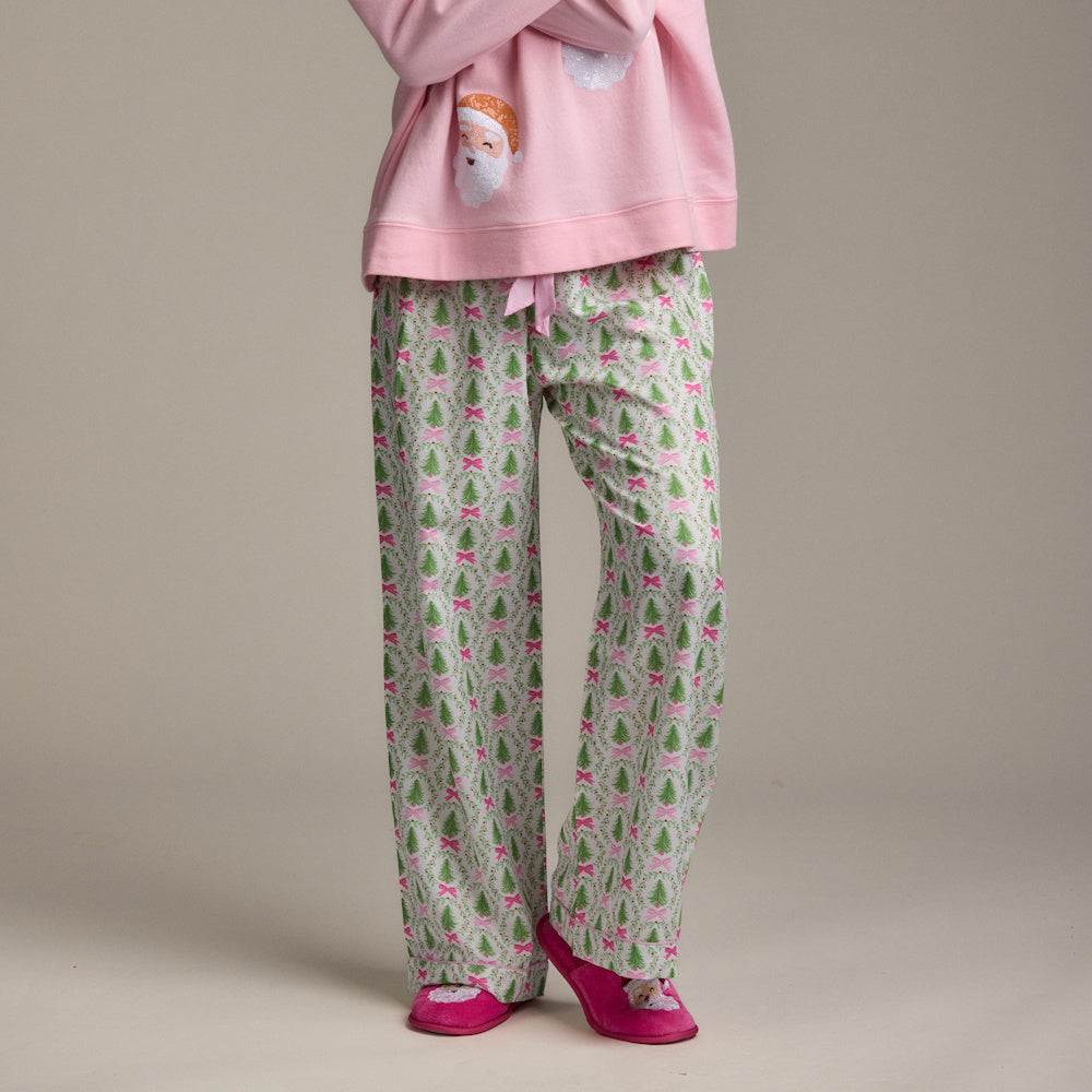 Holiday pajama set featuring a pink Santa sweatshirt and matching Christmas tree print pants with pink slippers.