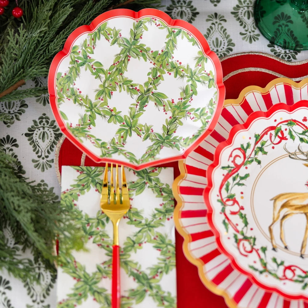 Flat lay view of a red, green, and white paper appetizer bowl with a festive holly lattice design.