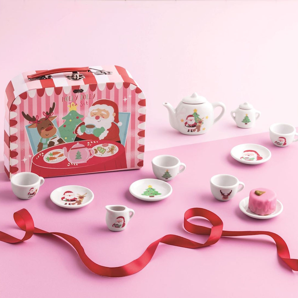Christmas-themed miniature toy tea set displayed next to its striped Santa storage case.