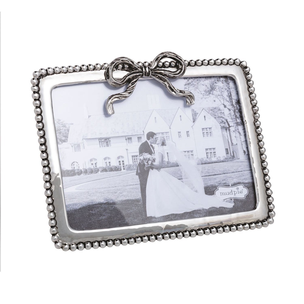 Silver beaded metal picture frame with a decorative bow on top by Mud Pie.