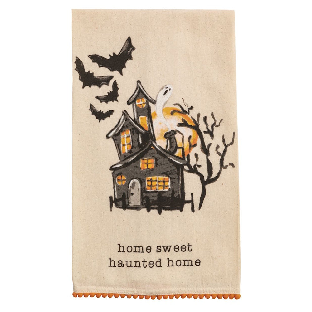 Halloween kitchen towel featuring a haunted house, bats, a ghost, and "home sweet haunted home" text.
