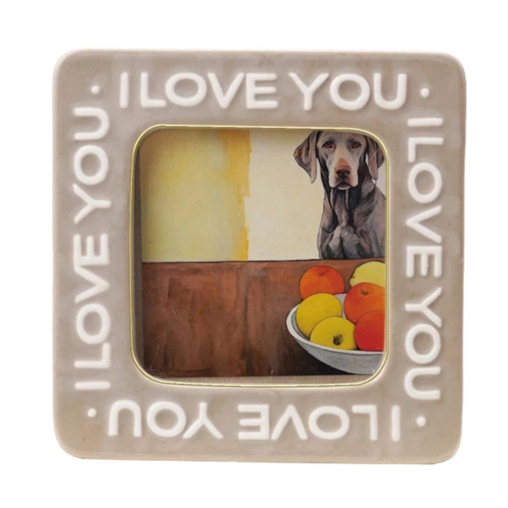 Beige "I Love You" embossed photo frame with gold trim, featuring a square opening and a picture of a dog and fruit.