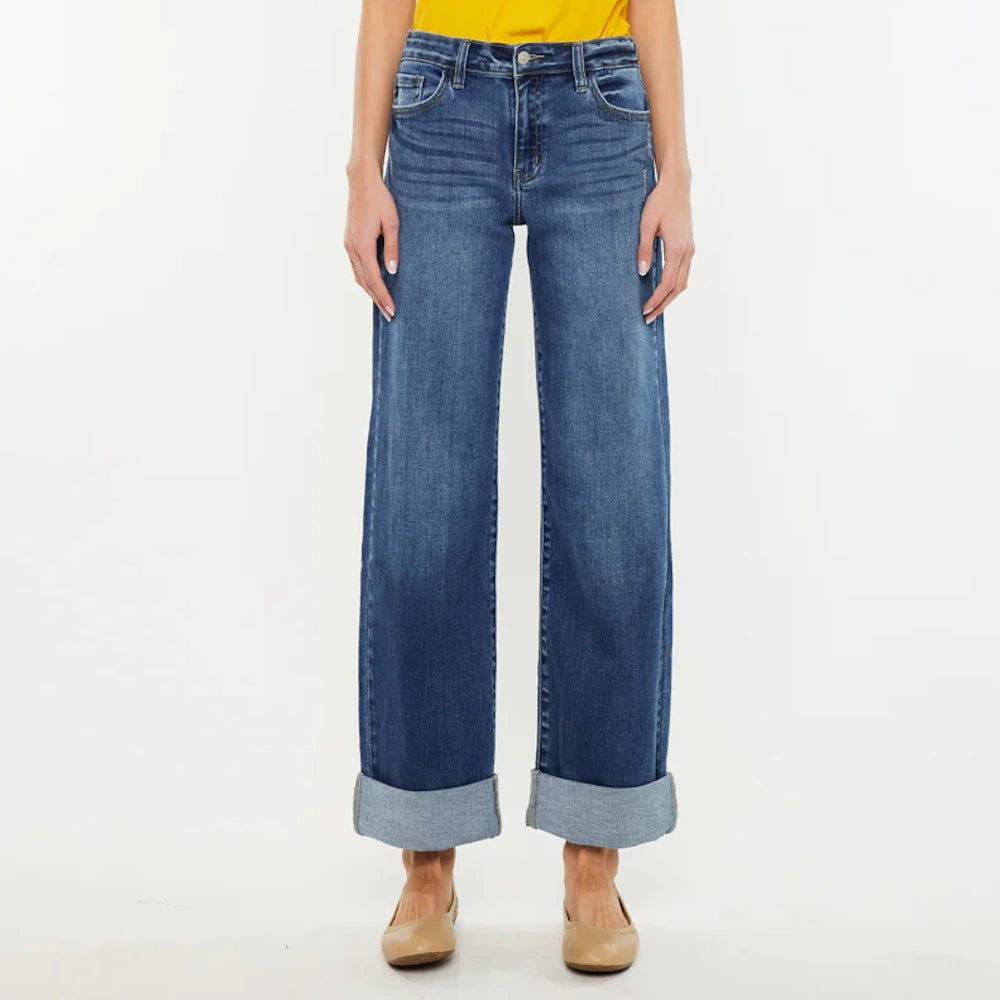 Ivanna Essentials high-rise wide-leg jeans in dark blue wash with large folded cuffs and tan flats.