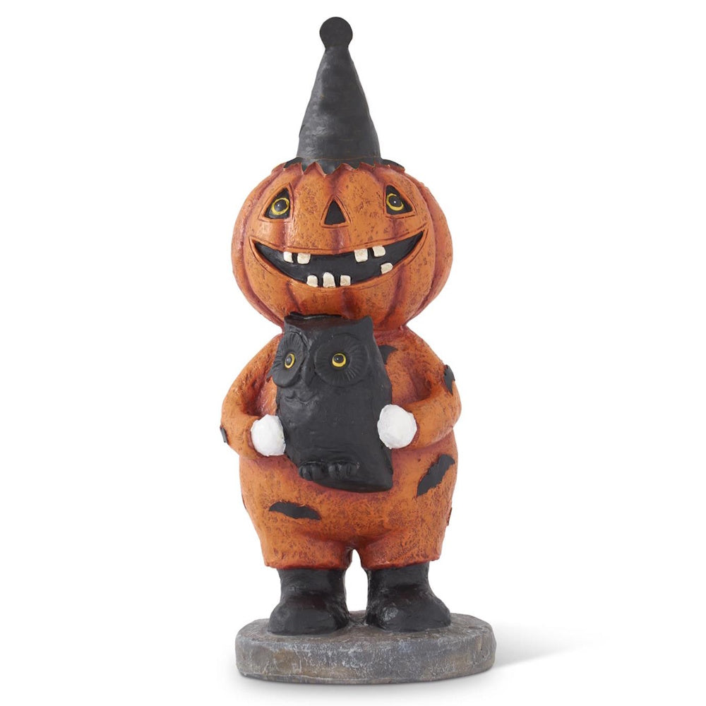 Vintage Halloween figurine of a smiling pumpkin character wearing a party hat and holding a black owl.