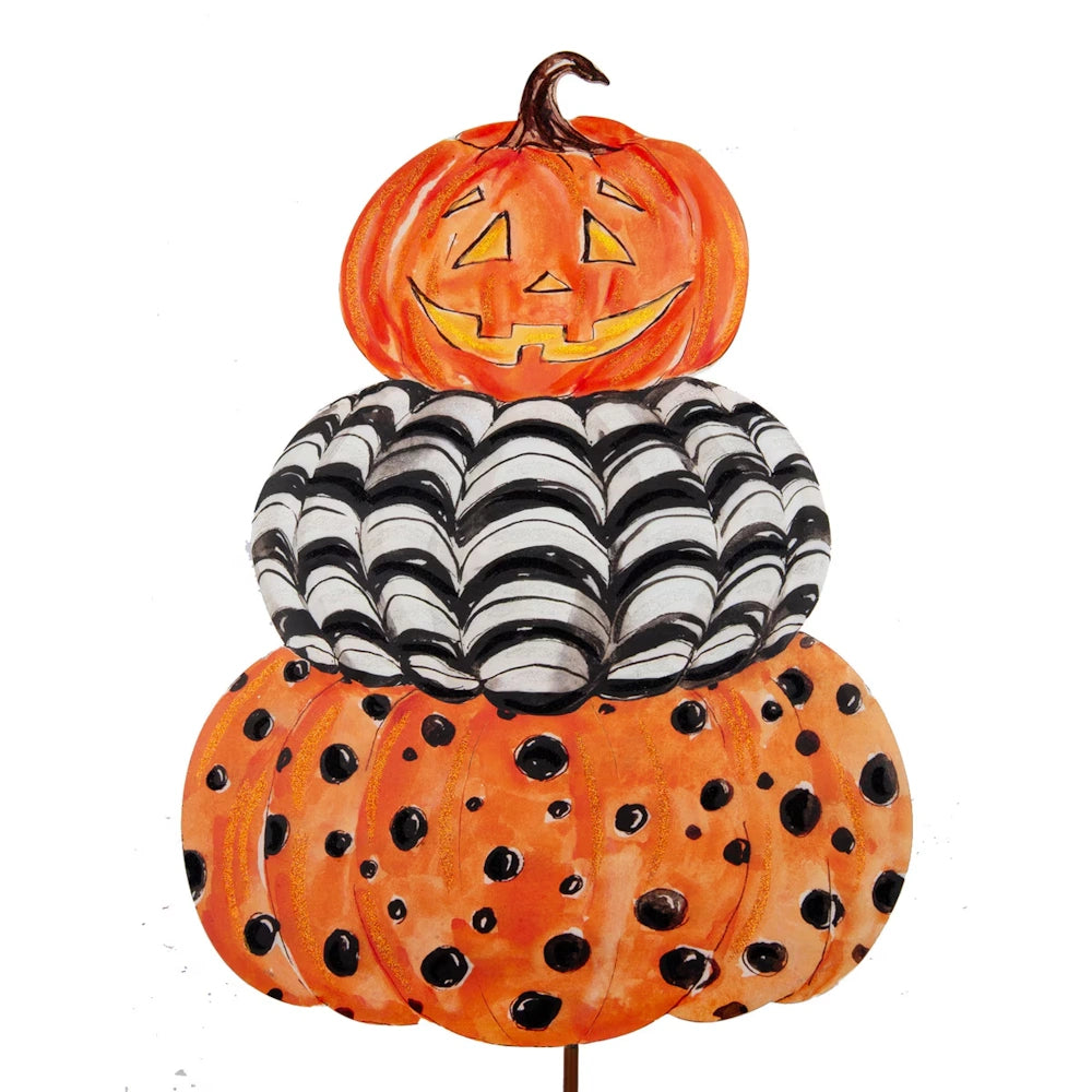 Watercolor illustration of stacked pumpkins: a jack-o'-lantern on top, black-and-white stripes, and polka dots.