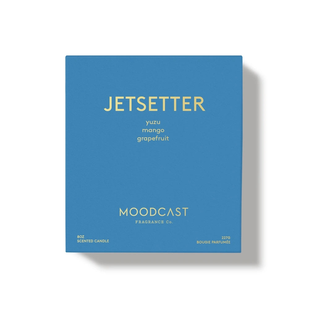 Blue Moodcast "Jetsetter" scented candle packaging box with gold text on a white background.