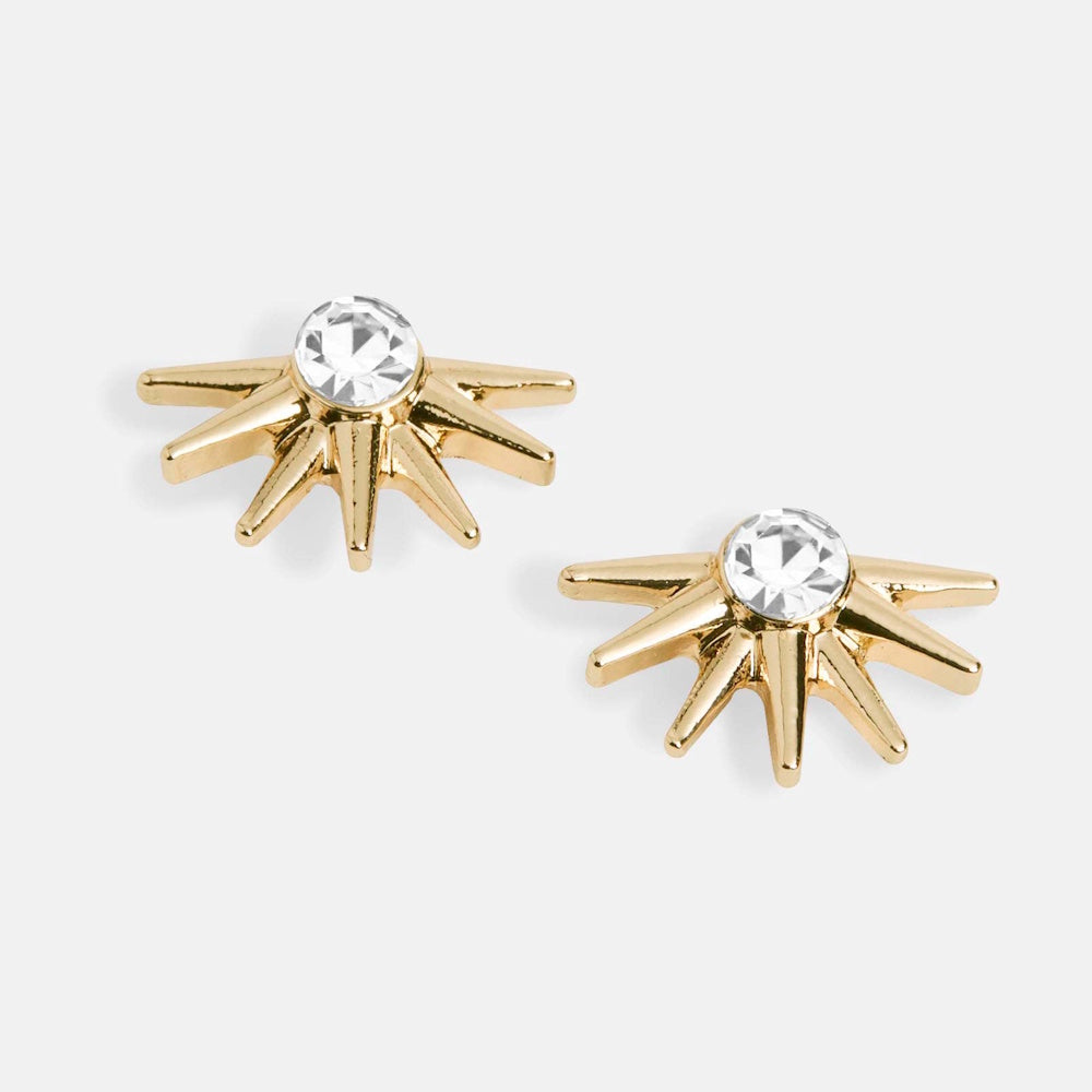 Gold starburst stud earrings with a central clear crystal jewel, minimalist sunburst design for elegant jewelry.