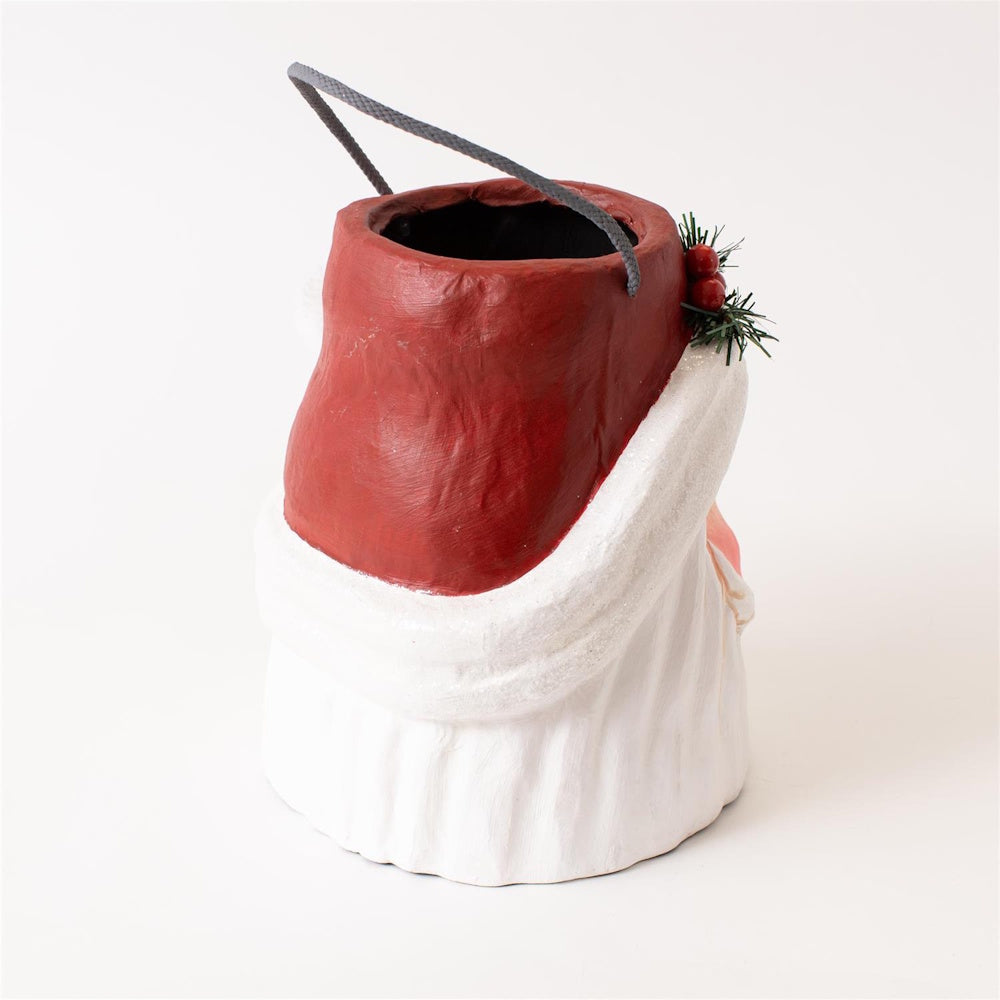 Back view of a Santa papier-mâché bucket with a red hat, white beard base, and grey handle.