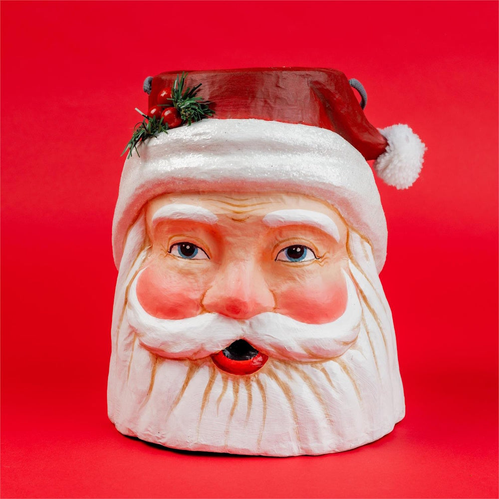 Vintage papier-mâché Santa Claus head bucket container set against a solid red background.