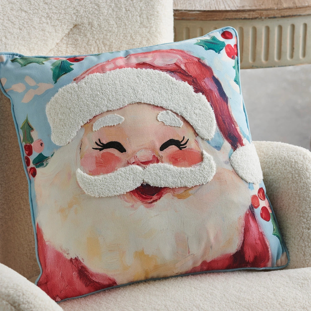 Santa Claus throw pillow resting on a white fuzzy armchair.