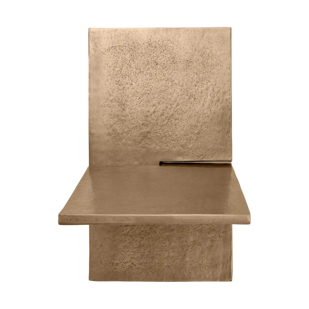 Front view of a minimalist, textured bronze metal book holder with geometric planes on a white background.