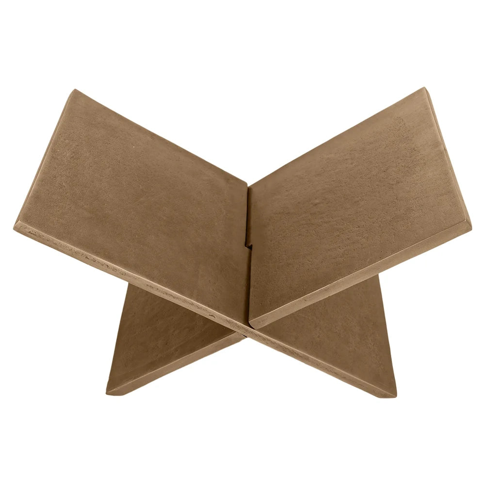 Top view of an X-shaped bronze book holder with a matte, textured surface on a plain white background.