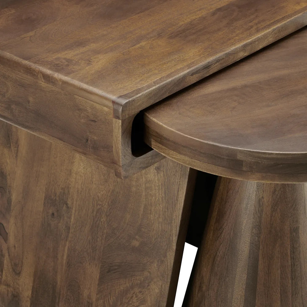 Close-up of brown wooden nesting coffee tables showing smooth grain details and overlapping design.