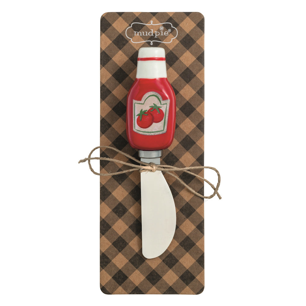 Mud Pie ceramic ketchup bottle cheese spreader with stainless steel blade on brown gingham packaging.