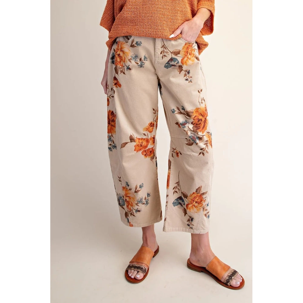Khaki floral corduroy barrel pants worn with brown sandals from the front.