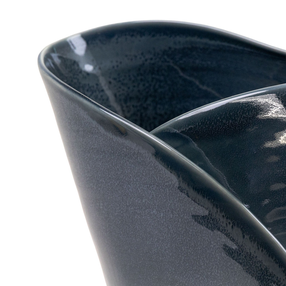 Close-up of a dark grey glazed ceramic bowl featuring a smooth, glossy finish and a modern, tapered design.