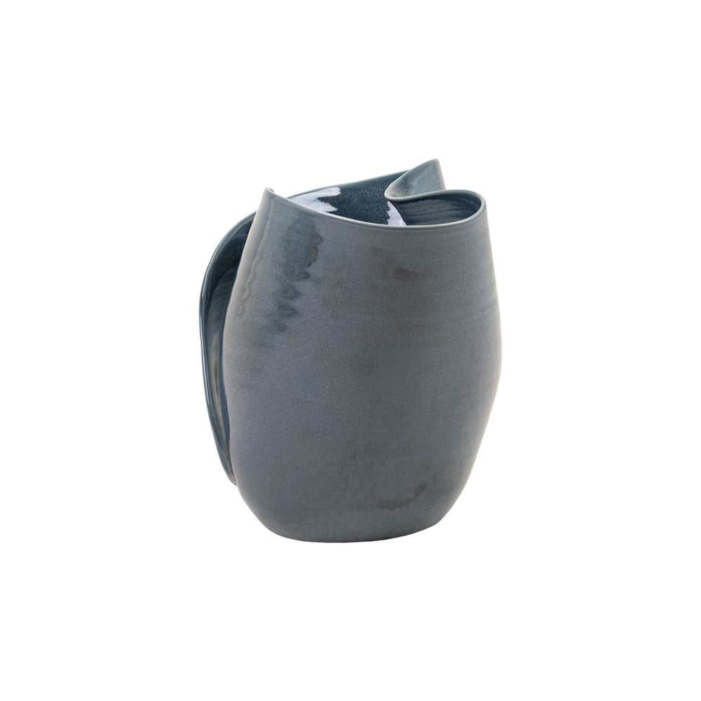 Side view of a dark blue Lamani ceramic bowl featuring an asymmetrical, folded rim and glossy glaze on a white background.