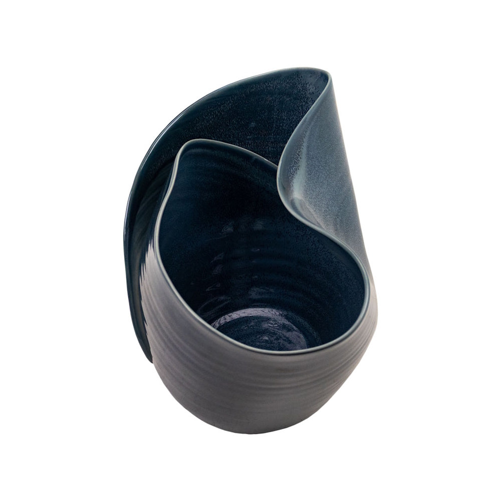 Top-down view of a dark blue ceramic bowl featuring a unique, sculptural folded rim and a glossy interior finish.