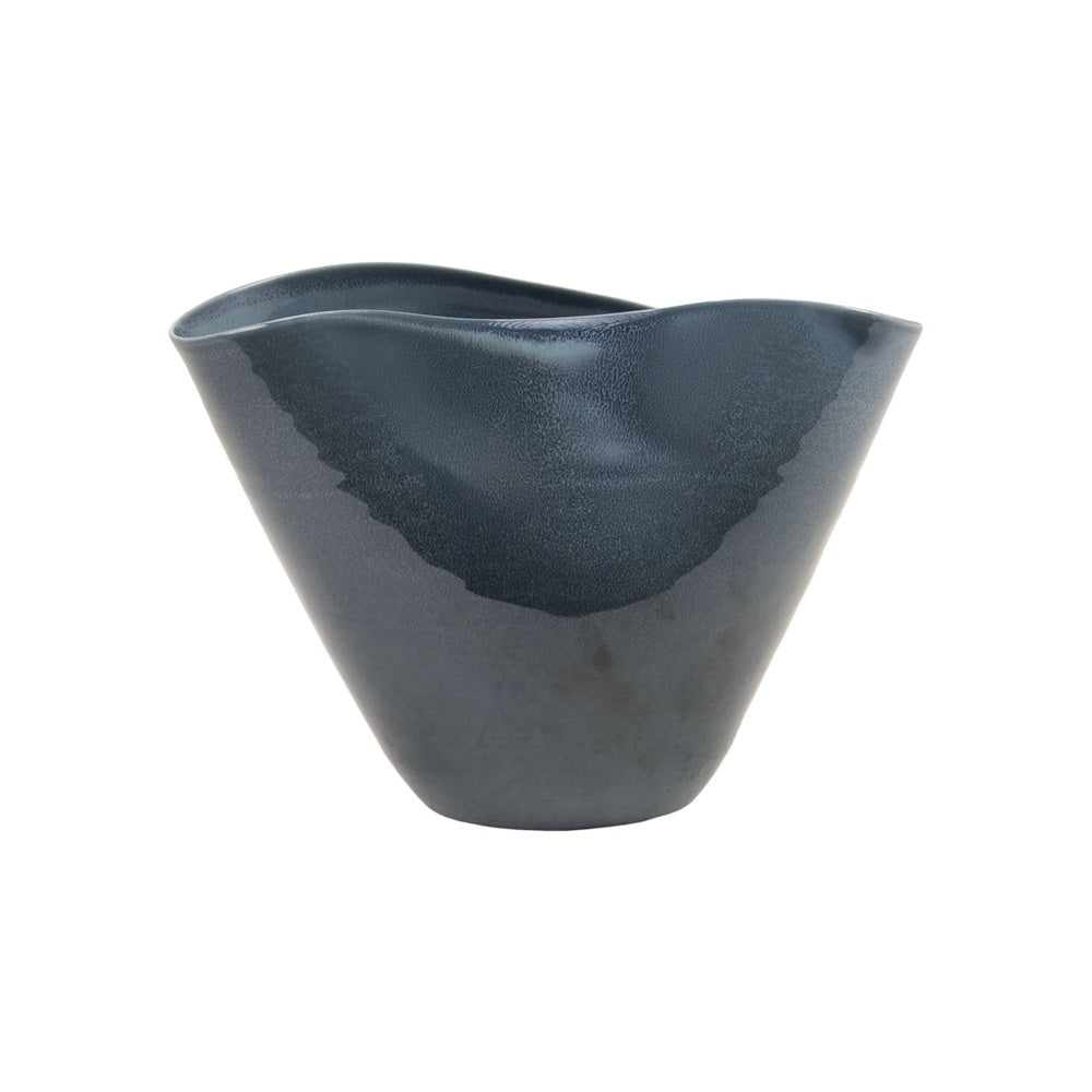 Side view of a tapered, dark blue ceramic bowl with a wavy, irregular rim and a glossy, textured finish.