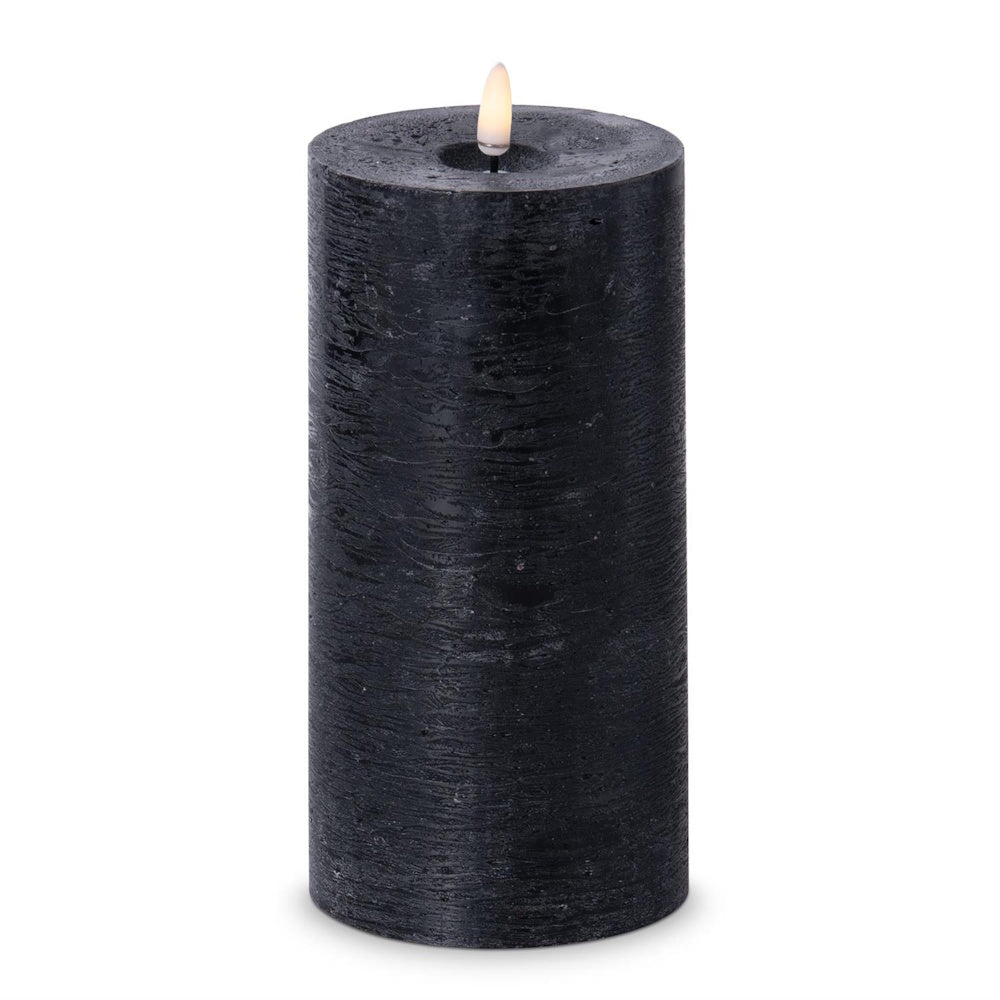 Tall black textured flameless LED pillar candle with a warm glowing faux flame.