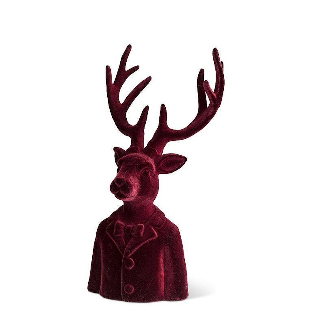 Velvet burgundy stag bust wearing a suit jacket and bowtie on a white background.