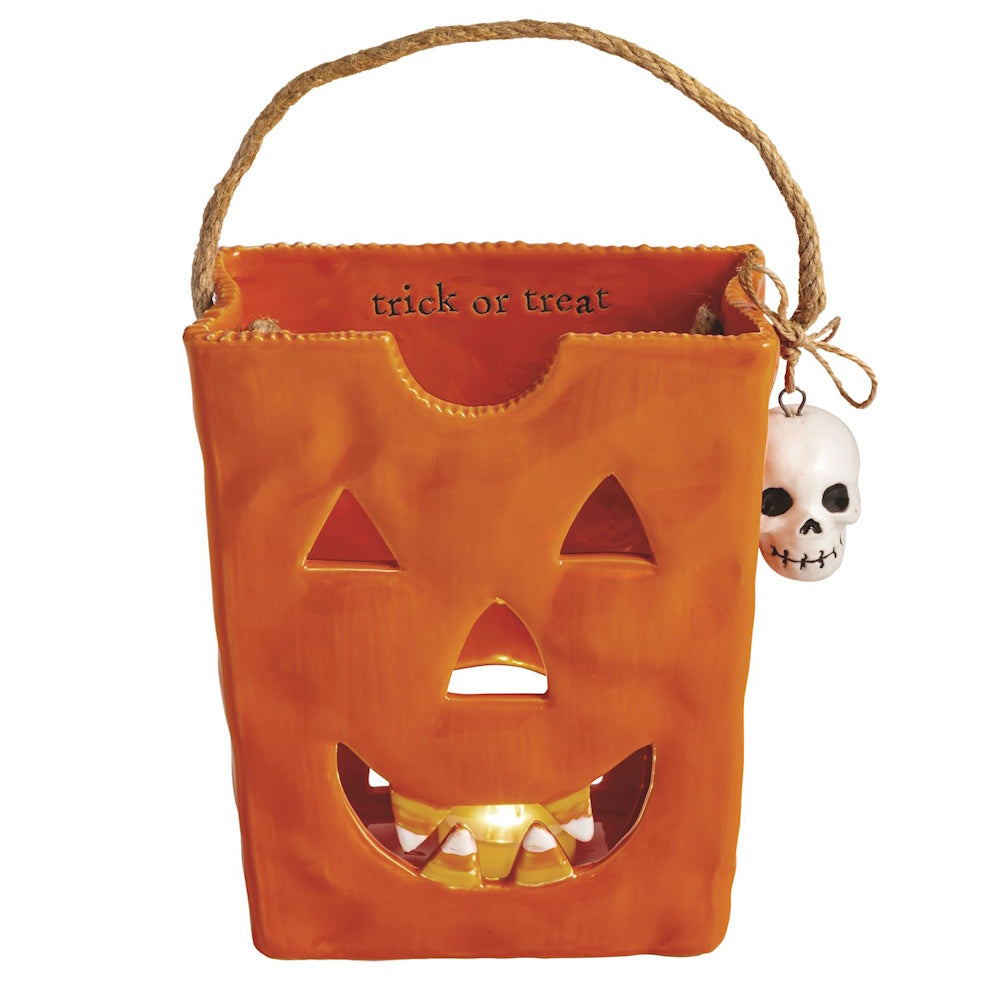 Orange ceramic jack-o'-lantern trick-or-treat bag lantern with a skull charm.