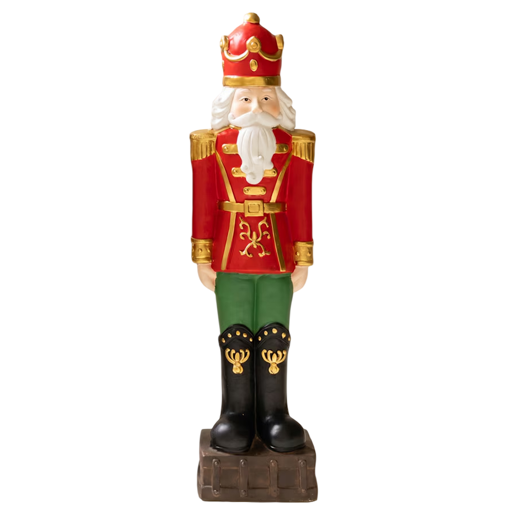 Large faux concrete Christmas nutcracker king statue wearing a red jacket, crown, and green pants.
