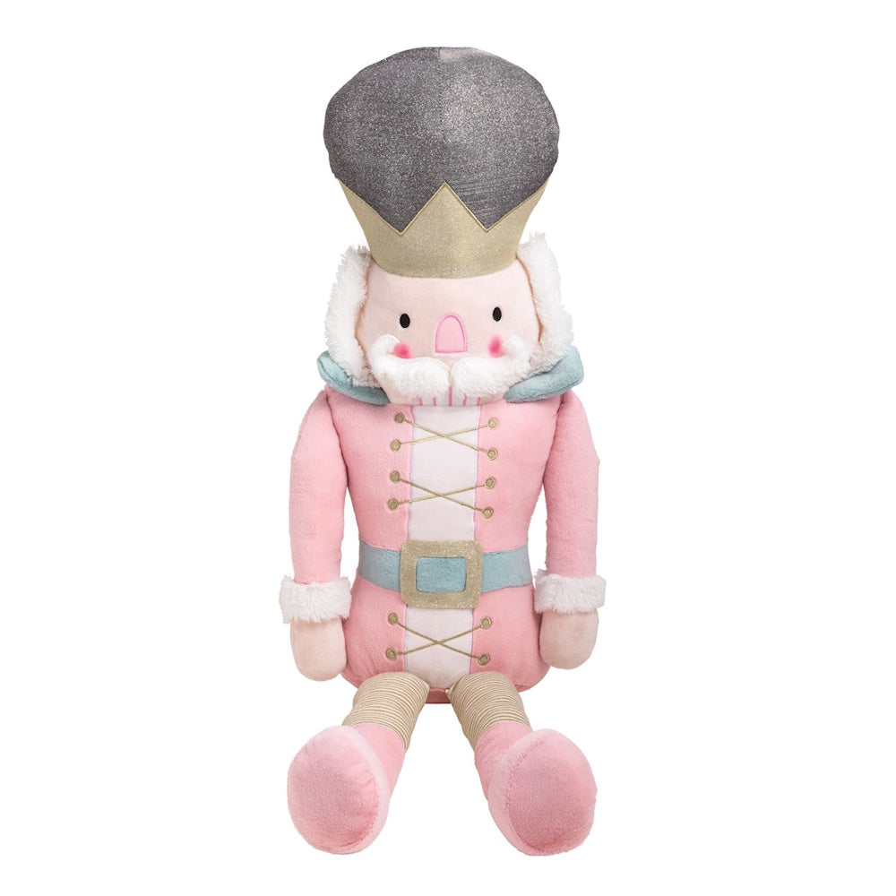 Plush nutcracker toy wearing a pink suit, gold belt, and tall silver glitter hat.