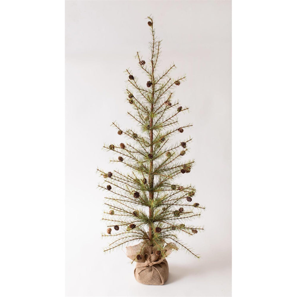 A slim, sparse pine tree decorated with small pinecones, wrapped in a burlap base.
