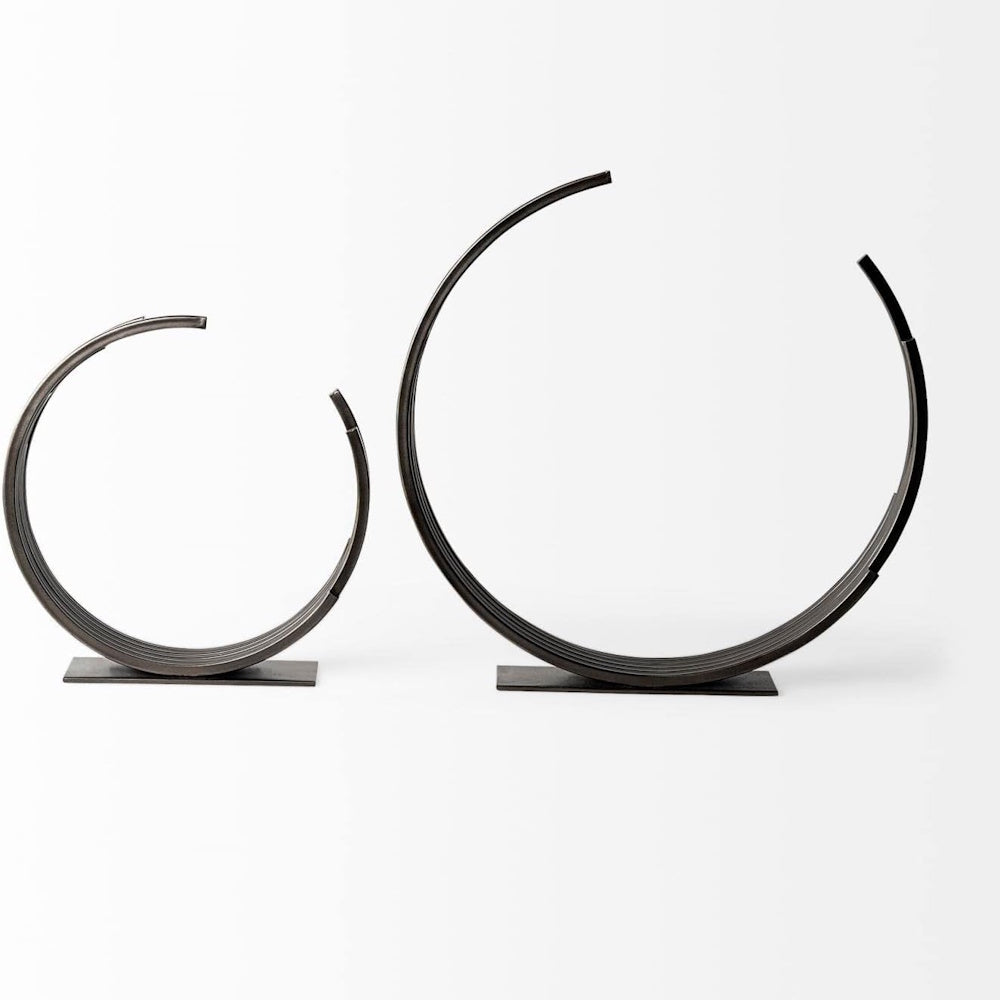 Two dark metal semi-circle Taj sculptures in small and large sizes on flat rectangular bases against a white background.