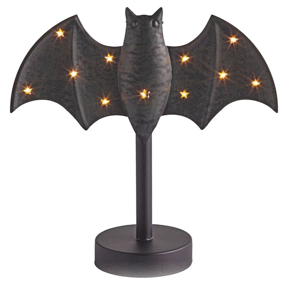 Black Halloween bat decoration on a stand with glowing star lights.