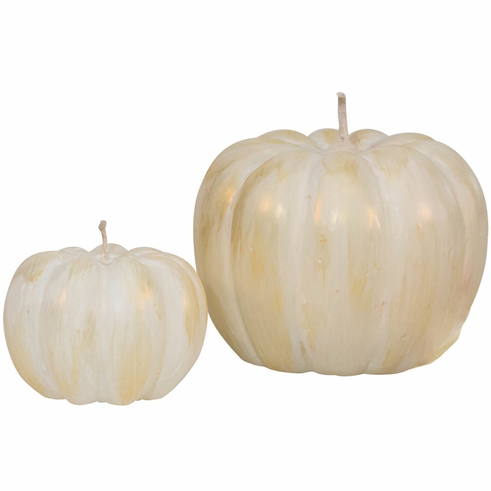 Two white and gold pumpkin-shaped candles, one large and one small, against a solid white background.