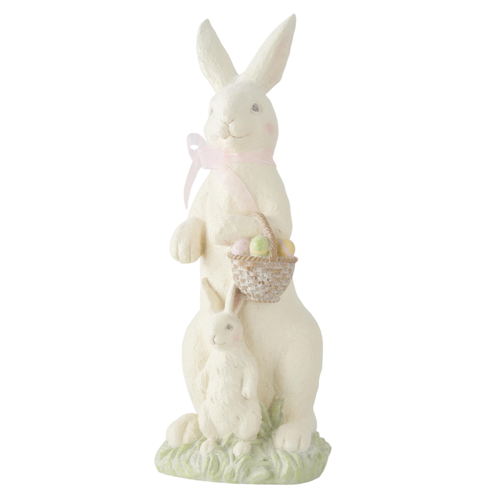 White resin Easter bunny figurine holding a basket of pastel eggs with a smaller bunny at its feet.