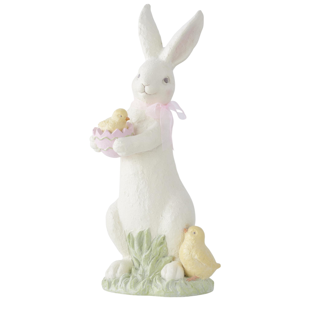 White resin Easter bunny figurine holding a chick in a pink egg, with a second chick at its base.