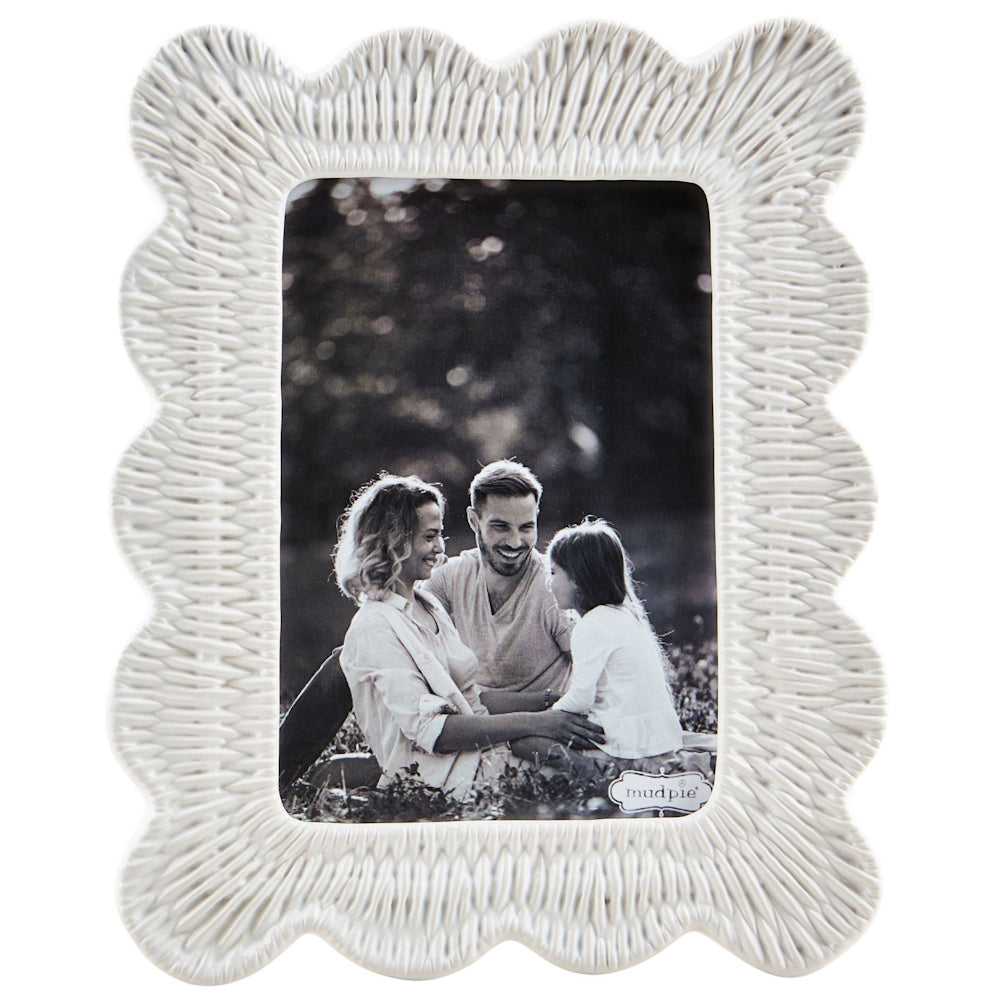 Scalloped white stoneware picture frame with a textured wicker pattern, featuring a black and white family photo.