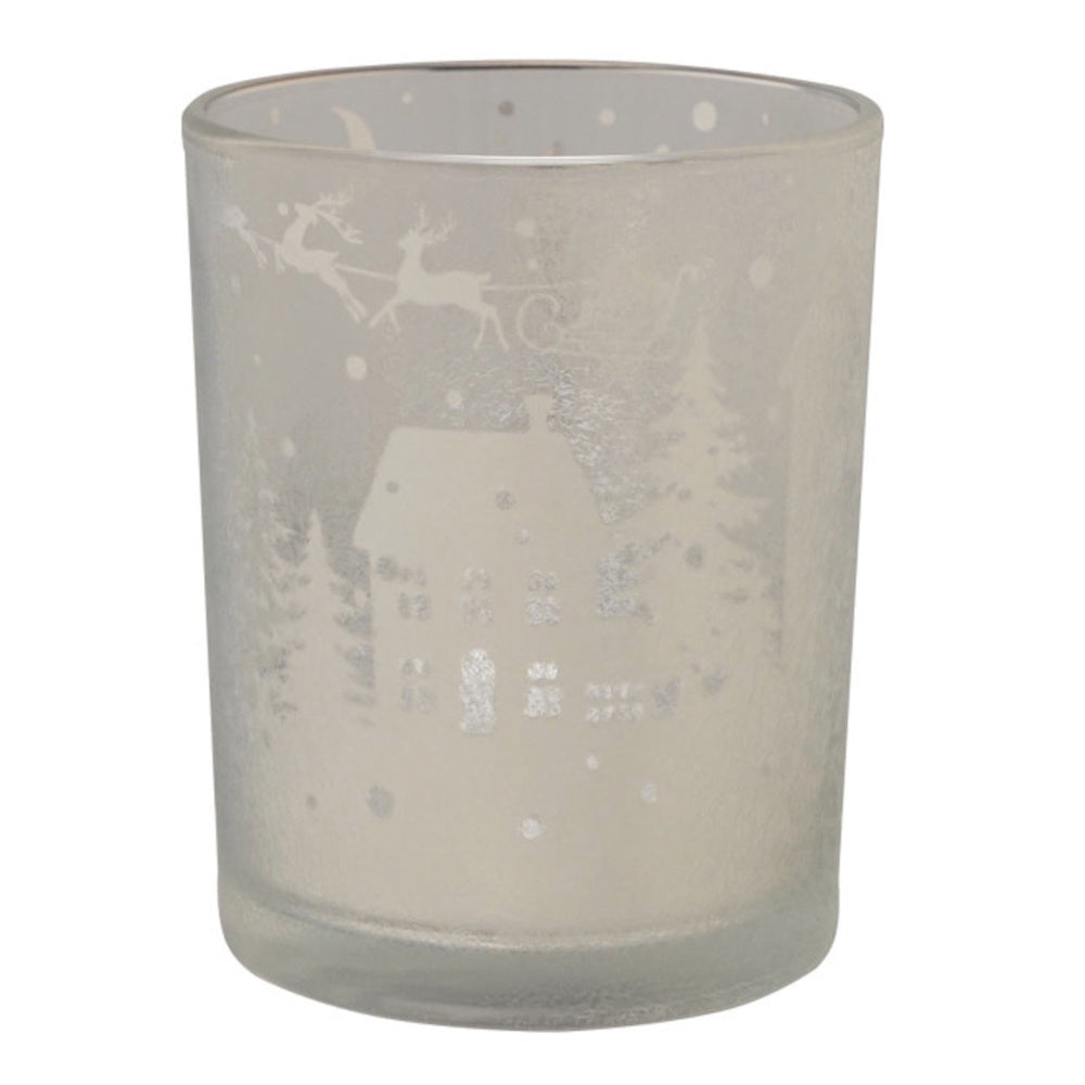 Frosted glass votive holder with etched winter scene of Santa's sleigh, houses, and trees.