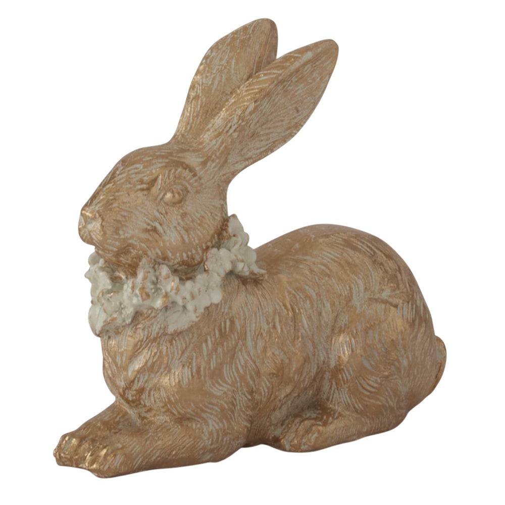 Gold resin Easter bunny figurine with textured fur and white flower collar on white background.