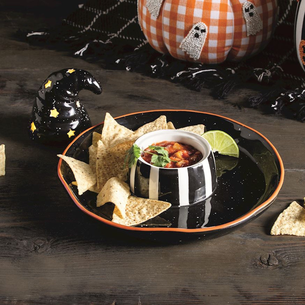 Halloween witch hat chip and dip platter with tortilla chips, salsa, and a lighted hat decoration.