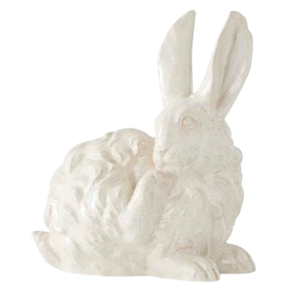 White glazed terracotta bunny figurine with long ears and textured finish, isolated on white background.