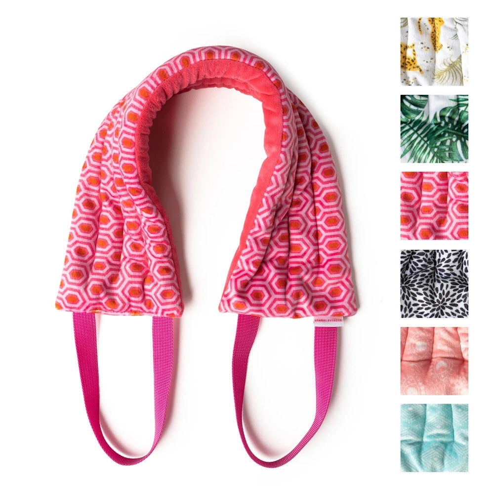 Lemon Lavender heated neck wrap in pink geometric pattern with hand straps and various pattern swatches on the side.