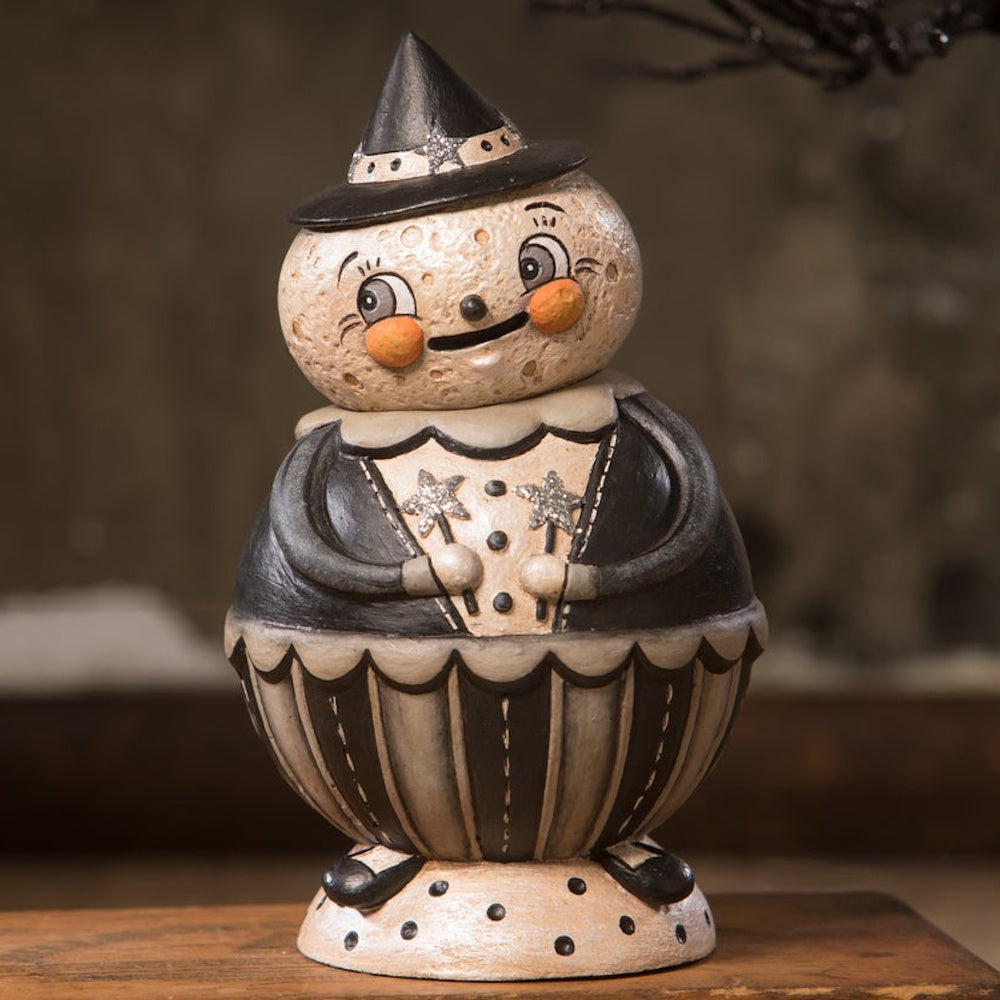 Vintage-style Halloween figurine jar featuring a smiling moon face in a witch hat and a striped outfit.