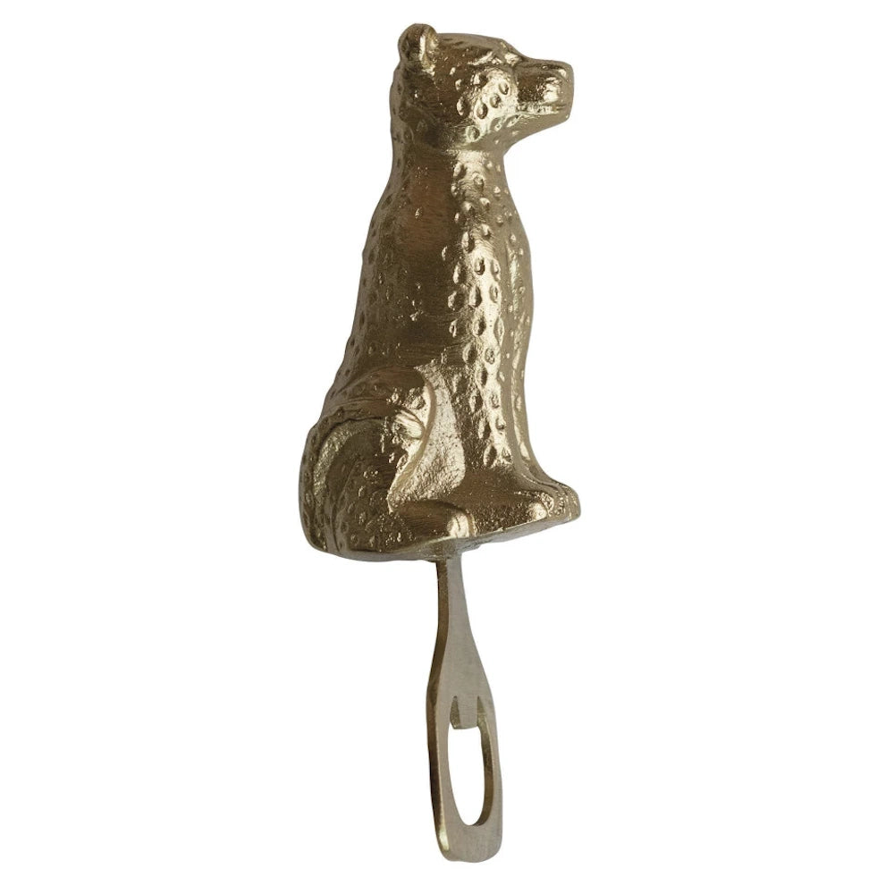 Gold cheetah bottle opener with a textured leopard spot design and a metallic finish, perfect for bar cart decor.